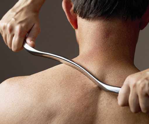 Graston Technique® applied to a patient's shoulder.